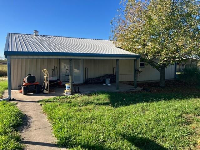 5487 Fm 512, Commerce, TX 75428 - rear view of property featuring a yard and metal roof
