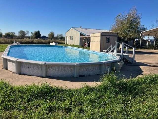 view of pool featuring a storage shed