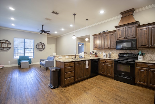 kitchen with kitchen peninsula, light wood-type flooring, ceiling fan, black appliances, and decorative light fixtures