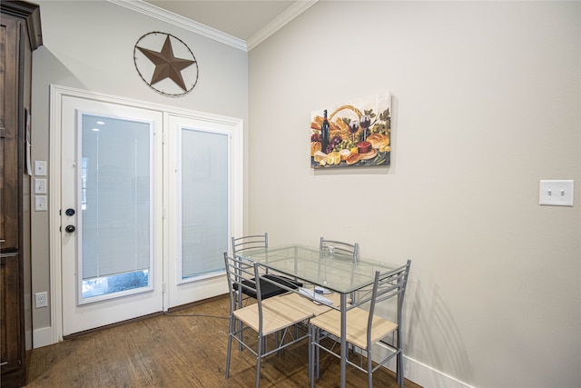 dining space featuring dark hardwood / wood-style flooring and ornamental molding