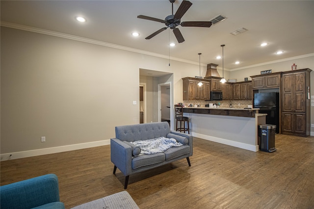 living room with ceiling fan, dark hardwood / wood-style flooring, and ornamental molding