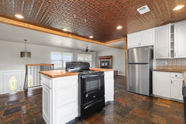 kitchen with white cabinets, stainless steel refrigerator, black electric range oven, and butcher block counters