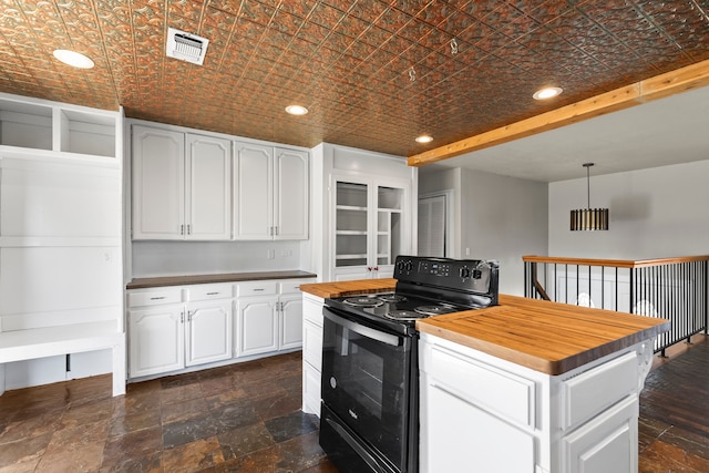 kitchen featuring hanging light fixtures, white cabinetry, black range with electric cooktop, a kitchen island, and butcher block counters