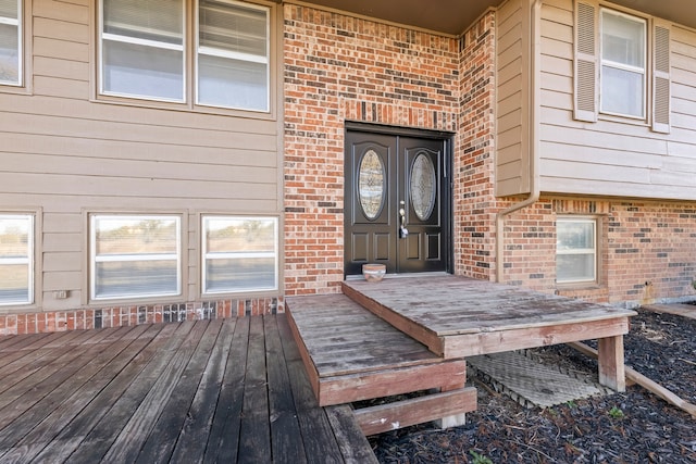 view of exterior entry featuring a deck