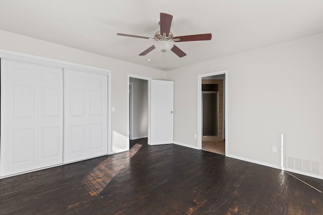 unfurnished bedroom featuring hardwood / wood-style floors, a closet, and ceiling fan