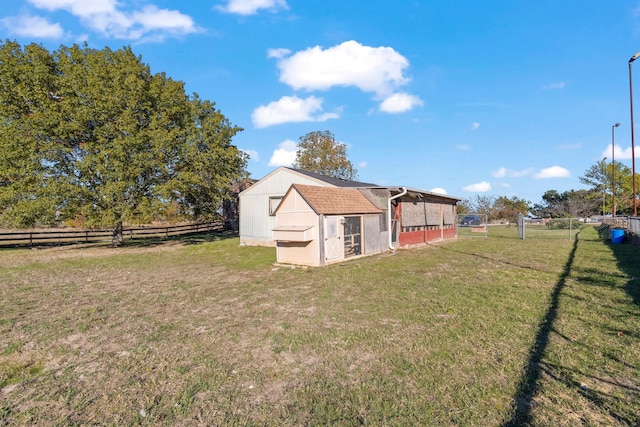 view of yard with a rural view and an outdoor structure