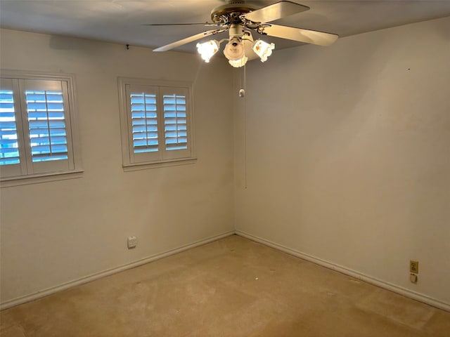 unfurnished room with light colored carpet and ceiling fan