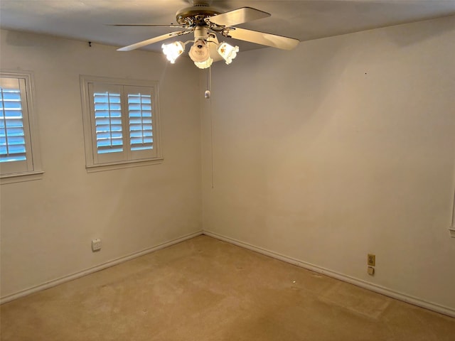 carpeted spare room with ceiling fan