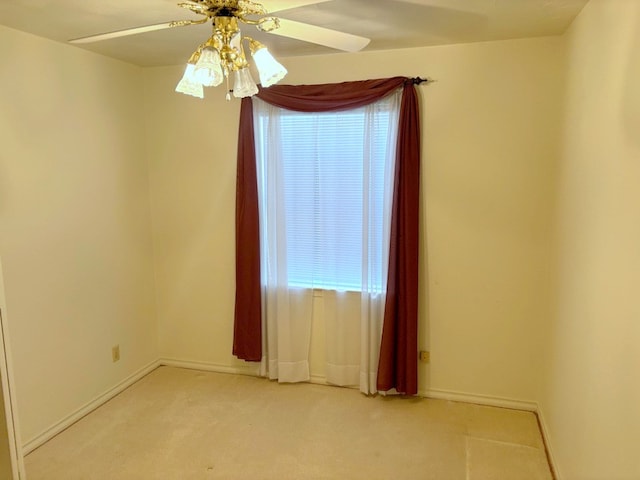 carpeted spare room featuring ceiling fan