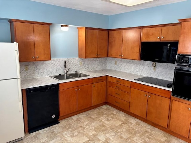 kitchen featuring sink, backsplash, and black appliances