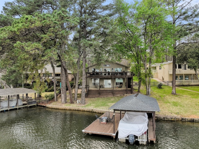 dock area featuring a lawn and a water view