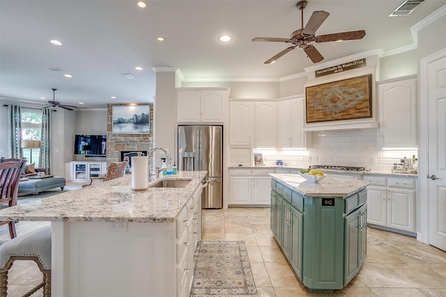 kitchen with green cabinets, white cabinets, a kitchen island, and appliances with stainless steel finishes