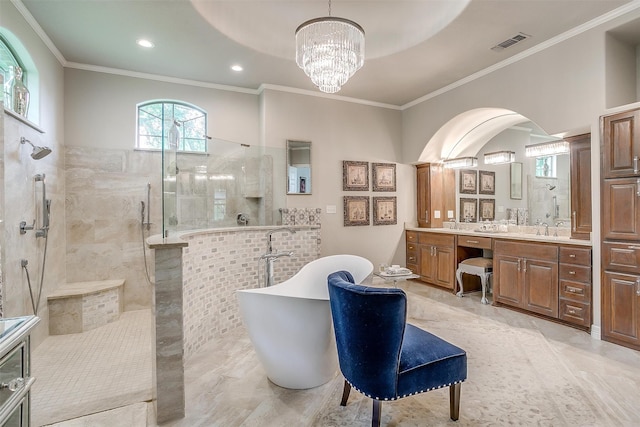 bathroom featuring a notable chandelier, vanity, separate shower and tub, and ornamental molding