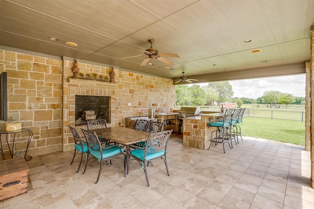 view of patio with ceiling fan and exterior bar