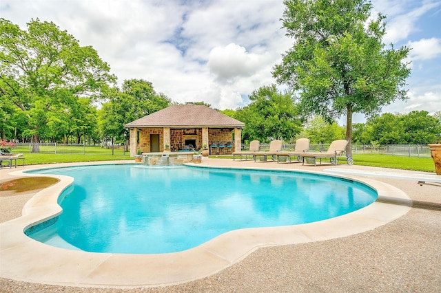 view of swimming pool with a patio area and a lawn