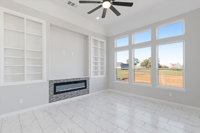 unfurnished living room with ceiling fan and built in features