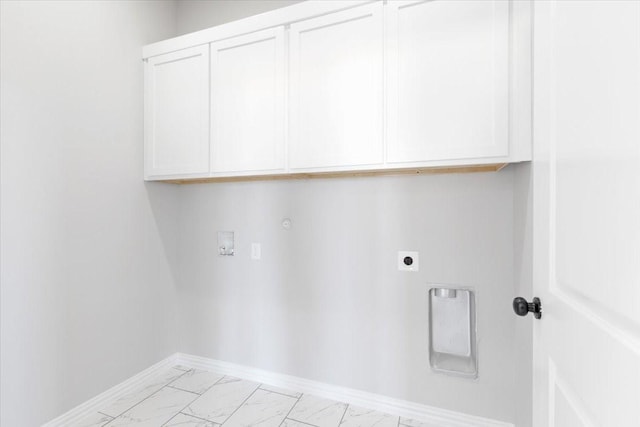 clothes washing area featuring cabinets, gas dryer hookup, hookup for an electric dryer, and hookup for a washing machine