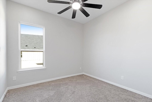 carpeted empty room with ceiling fan and plenty of natural light