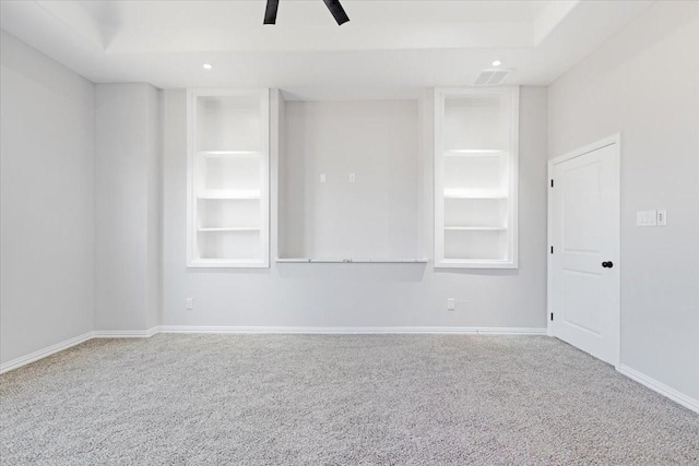 unfurnished room featuring carpet, built in features, and ceiling fan