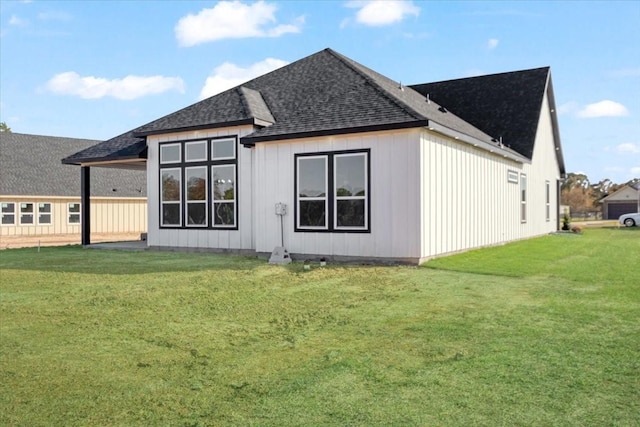 rear view of house featuring a lawn