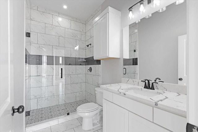 bathroom with vanity, a shower with door, and toilet