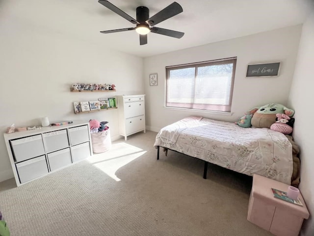 bedroom featuring light colored carpet and a ceiling fan