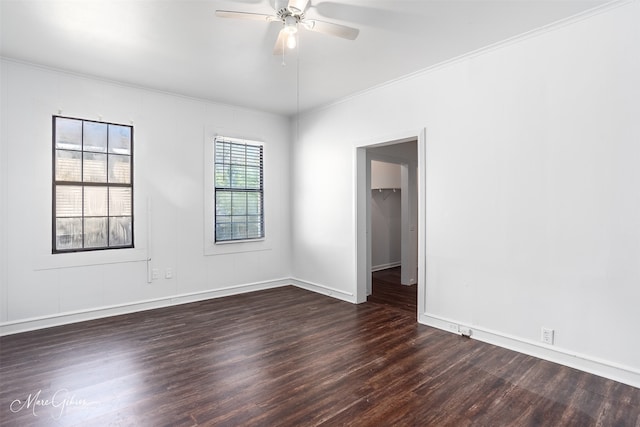 spare room featuring ceiling fan, ornamental molding, and dark wood-type flooring