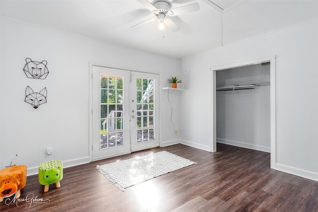 unfurnished bedroom featuring dark wood-type flooring, french doors, crown molding, ceiling fan, and a closet