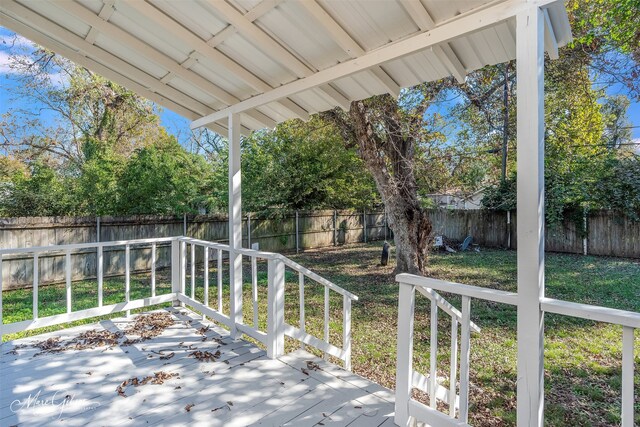 wooden terrace with a lawn