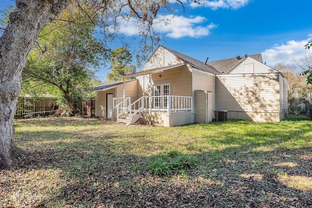 back of house featuring a yard and a wooden deck