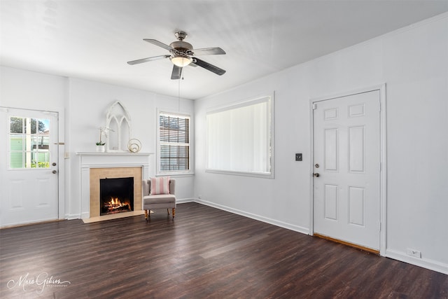 unfurnished living room featuring ceiling fan and dark hardwood / wood-style flooring