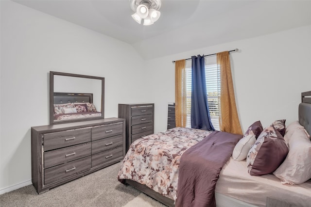 bedroom featuring ceiling fan, light colored carpet, and vaulted ceiling