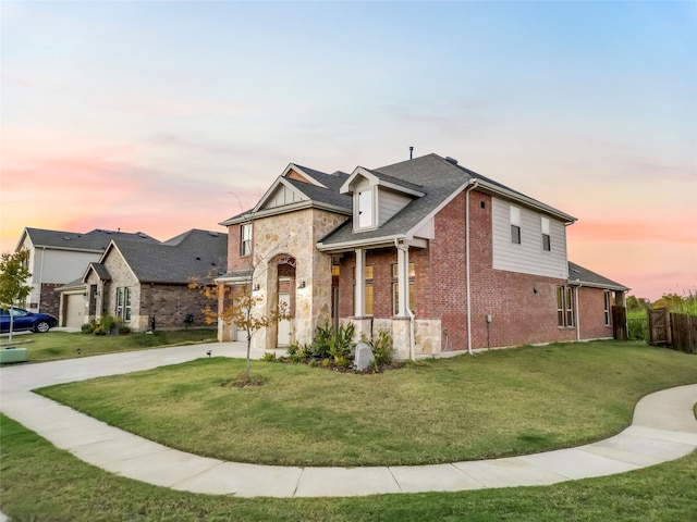 view of front of property featuring a yard and a garage