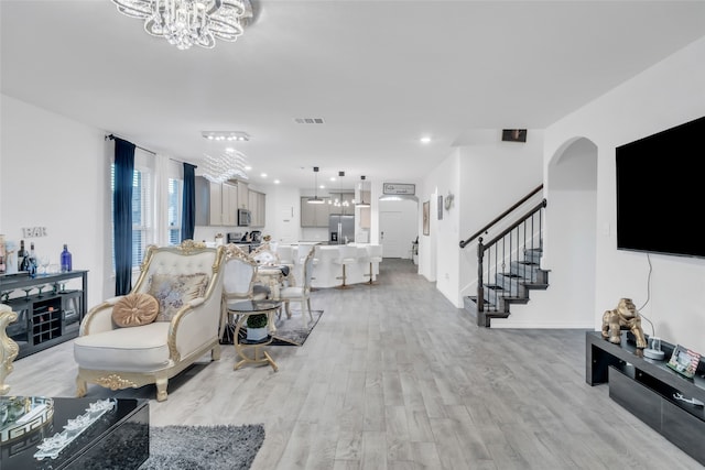 living room featuring light hardwood / wood-style floors and a chandelier