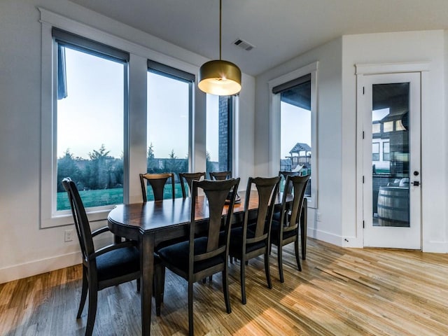 dining space with hardwood / wood-style flooring and plenty of natural light