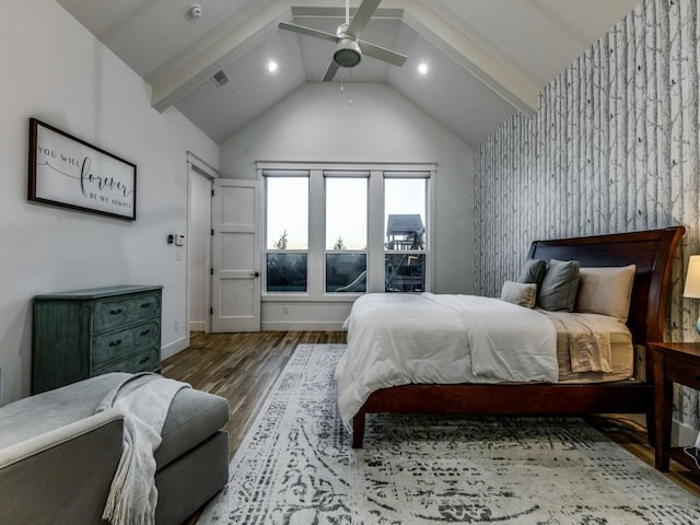 bedroom featuring ceiling fan, dark hardwood / wood-style flooring, and lofted ceiling with beams