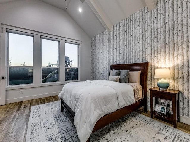 bedroom with lofted ceiling and light hardwood / wood-style floors