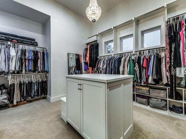 spacious closet with light carpet and a notable chandelier