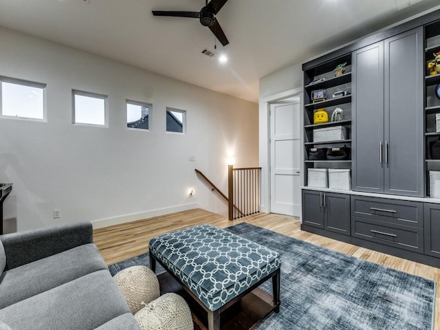 living room featuring ceiling fan and light wood-type flooring