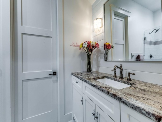 bathroom featuring vanity and a shower