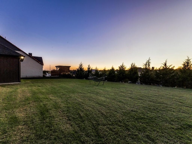 view of yard at dusk