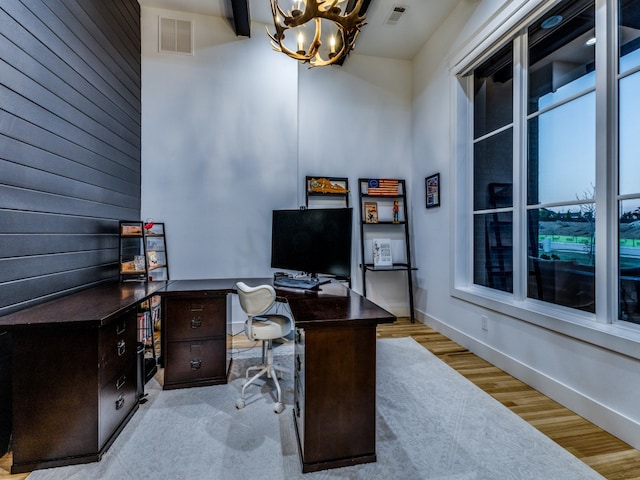 office area featuring an inviting chandelier and light hardwood / wood-style floors