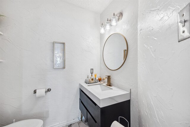 bathroom with a textured ceiling and vanity