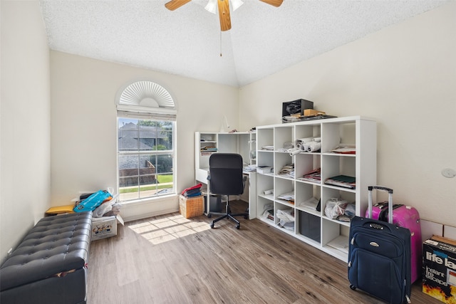 home office with wood-type flooring, a textured ceiling, ceiling fan, and lofted ceiling