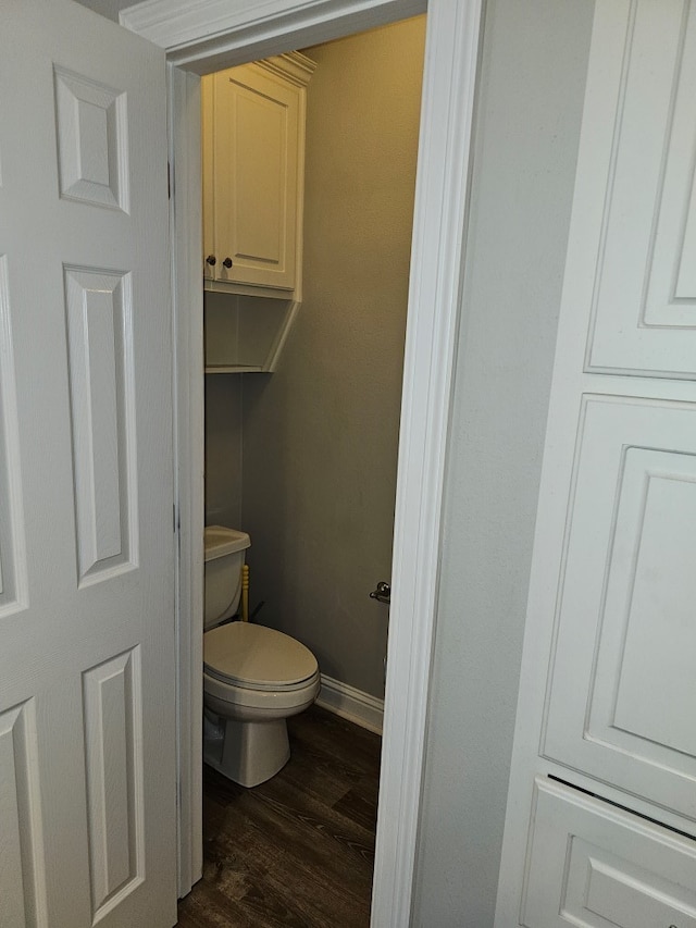 bathroom with hardwood / wood-style flooring and toilet