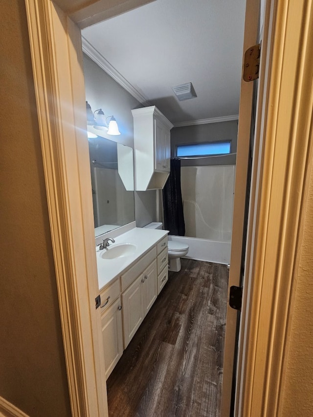 full bathroom with vanity, toilet, shower / bathtub combination with curtain, ornamental molding, and wood-type flooring