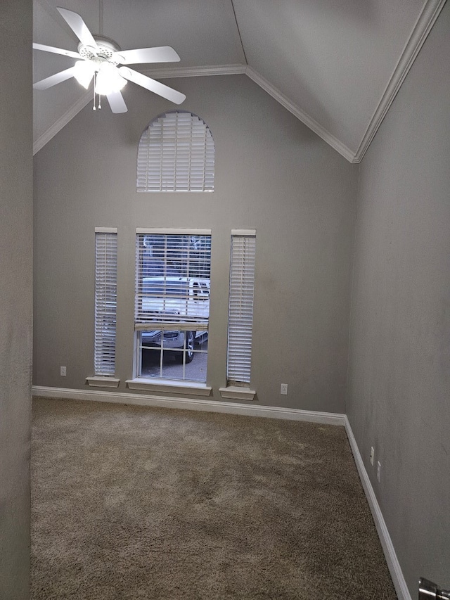 carpeted empty room with ceiling fan, crown molding, and vaulted ceiling