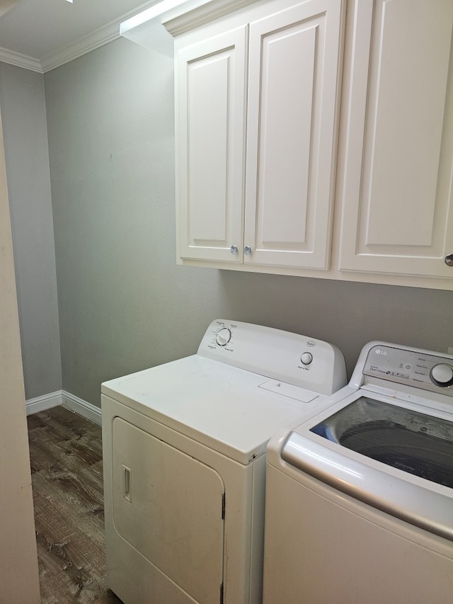 washroom with separate washer and dryer, crown molding, cabinets, and dark hardwood / wood-style floors