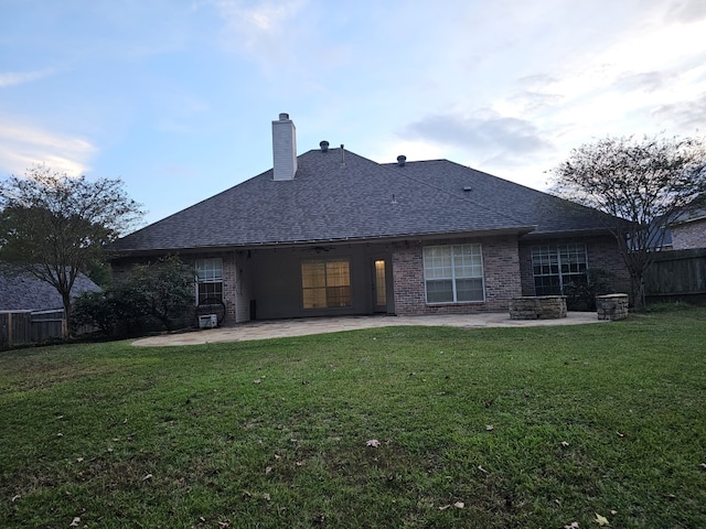 rear view of house with a patio area and a yard