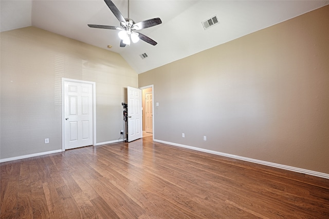 spare room featuring wood-type flooring, vaulted ceiling, and ceiling fan